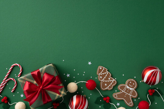 Vibrant Christmas celebration scene featuring a wrapped gift with red ribbon, candy canes, gingerbread cookies, and ornaments on a green background, evoking festive cheer gifts and holiday greetings