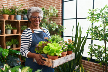 Smiling Older Woman Gardener Holding Fresh Lettuce Plants in a Nursery