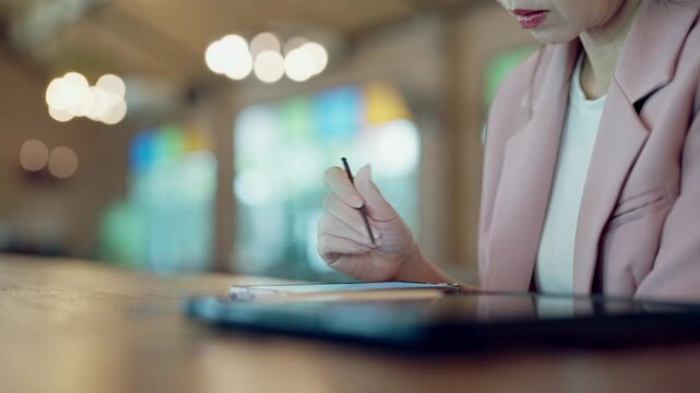 Female UX designer working on interface design with stylus, smartphone and tablet for cross-platform interaction