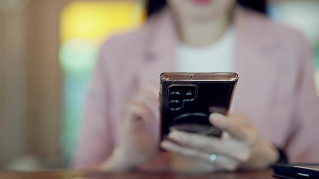 Close-up of woman hand using smartphone in a casual modern environment, tech-savvy lifestyle and communication concept