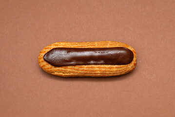 Chocolate éclair on brown background