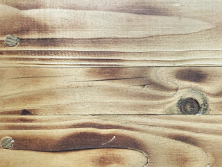 Close-up of weathered wood grain texture with visible knots and screws