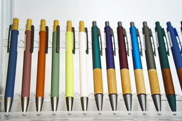 Ballpoint pens are displayed in a row. Sale of office supplies.