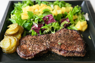 Healthy steak and salad meal on table at home