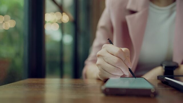 Artistic concept of female hand drawing or designing with stylus on digital devices like smartphone and tablet