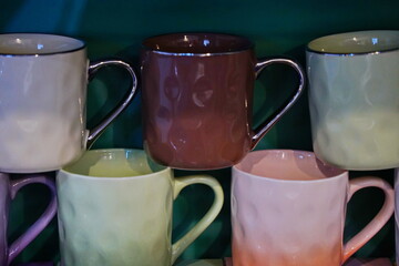 Various ceramic mugs are displayed on the table.