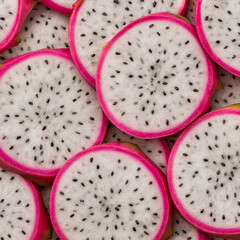 Close up of fresh dragon fruit slice with white pulp and black seeds, exotic tropical fruit background for healthy eating and organic design.