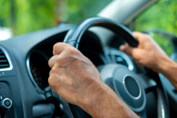 Naklejka premium hand on steering wheel captures focus and control of operating vehicle, Driving experience, Road journey, Automotive lifestyle, Safety and control, human interaction with modern transportation