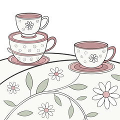 Whimsical tea cups and daisies on a tablecloth