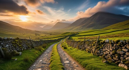 Dramatic sunset over rolling green hills and stone wall pathway