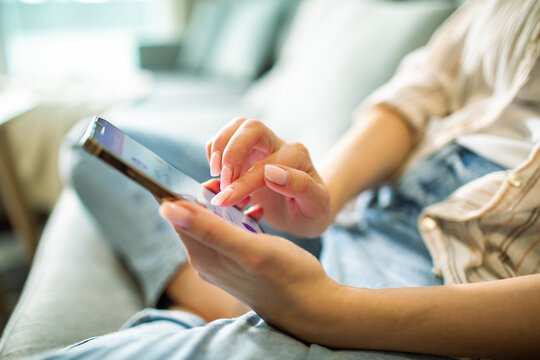 Woman using smartphone at home