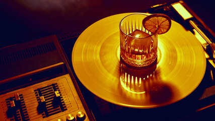 Cocktail with lemon slice served on glowing golden vinyl record. Concept of bar culture, music and vinyl lifestyle, luxury branding, entertainment marketing, and creative nightlife visuals.