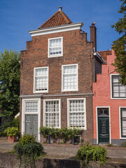 Charming canal houses with Dutch gabled roofs and cobblestone street in Leiden, Netherlands
