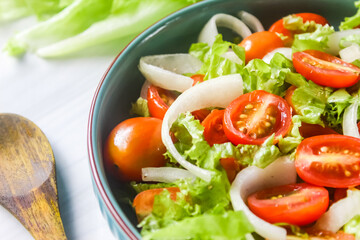 close up of tomato salad with mixed onions and lettuce on the table.dietary food
