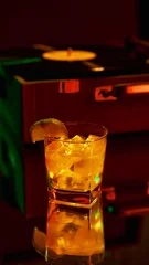Wandcirkels Bar Golden cocktail with lime slice in glass beside vintage vinyl record player in neon ambiance. Concept of bar culture, luxury lifestyle, creative marketing, and emotional nightlife experiences.  © master1305