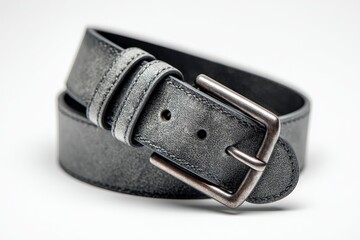 A gray leather belt is coiled with the buckle in view displayed on a white surface