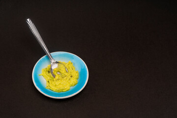 Guacamole sauce on a black background
