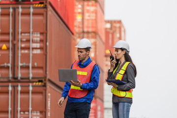 Logistics workers inspecting cargo at shipping port, Male and female engineers with laptop and walkie-talkie at a container yard, Team of dock workers managing logistics at freight terminal