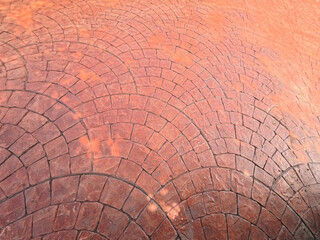 The red brick walkway is arranged in a curved line.