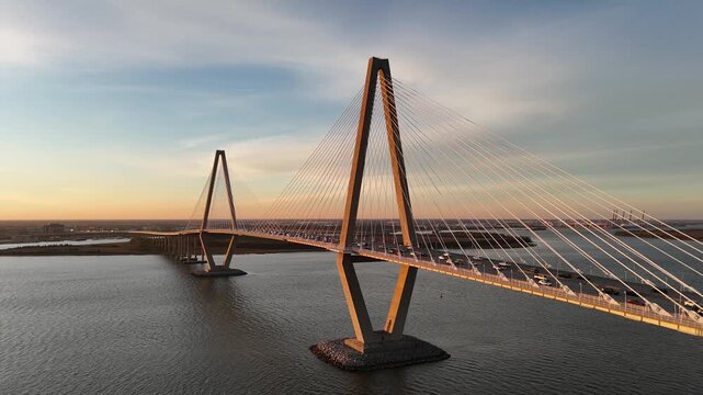 Car driving over Arthur Ravenel Jr Bridge Cooper River 4K aerial drone shot Charleston South Carolina at sunset