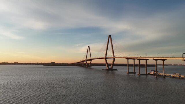 Arthur Ravenel Jr Bridge cars driving over Cooper River 4K aerial drone shot Charleston South Carolina at sunset