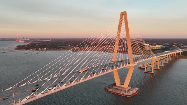Car driving over Arthur Ravenel Jr Bridge Cooper River 4K aerial drone shot Charleston South Carolina at sunset