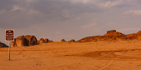 A sign warning against sand drifting near Al Ula in the desert of Saudi Arabia