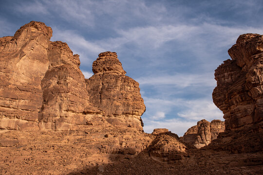 Three isolated red man-like rocks near Al Ula in the desert of Saudi Arabia