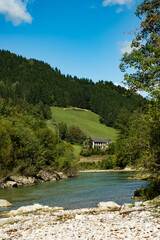 Obraz premium Idyllic Alpine Countryside with Forested Hills and Charming Austrian Settlement