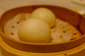 Close-up of dim sum custard bun. Traditional and common food in Yam Cha Culture. Chinese culture and Chinese cuisine. Food and beverage concept.
