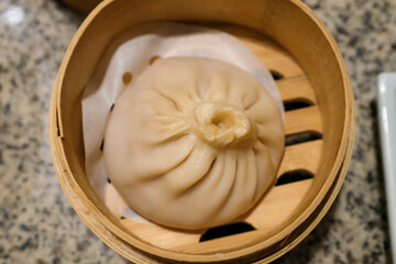 Close-up of the soup dumplings, xiaolongbao. Traditional, common and popular food in Yum Cha culture. Chinese culture and Chinese cuisine. Food and beverage concept.