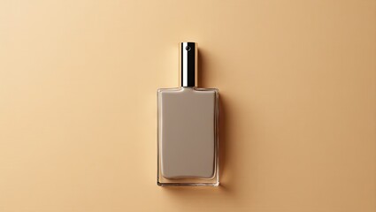 A rectangular, light taupe perfume bottle with a metallic top sits atop a muted beige surface, showcasing simple elegance and minimalist design.