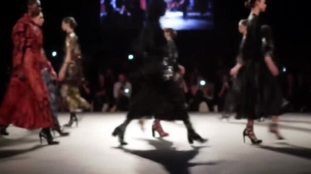 Models walking runway during fashion show