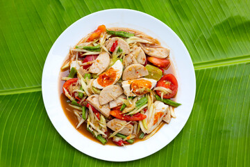 Spicy papaya salad with salted egg and vietnamese pork sausage