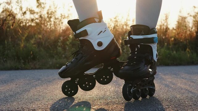 Bright sunlight illuminates the skater's feet as they glide confidently on inline skates, surrounded by lush greenery