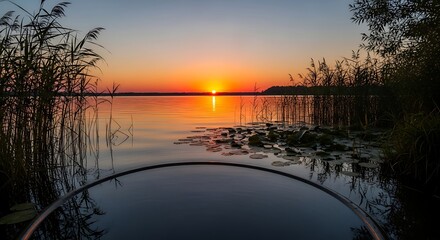Obraz premium Experience a tranquil sunrise kayaking adventure on a serene lake with vibrant colors and peaceful scenery