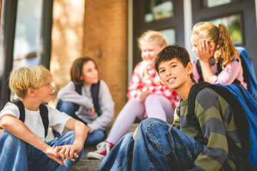 Group Of Young Children Hanging Out In Playground