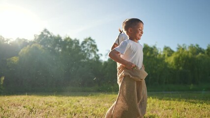 Boy and girl jump in playful race. Happy children enjoy outdoor summer. Grass under running feet. Racing brings joyful smiles. Playful jumping fills outdoor scene. Summer keeps boy girl happy. - Powered by Adobe