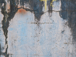 Fototapeta premium Weathered blue concrete wall with grunge texture, peeling paint, and stains, perfect for backgrounds, vintage design, or abstract industrial surfaces.