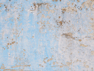 Weathered blue concrete wall with grunge texture, peeling paint, and stains, perfect for backgrounds, vintage design, or abstract industrial surfaces.