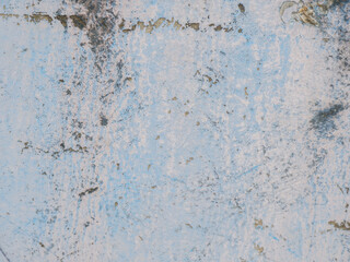 Weathered blue concrete wall with grunge texture, peeling paint, and stains, perfect for backgrounds, vintage design, or abstract industrial surfaces.