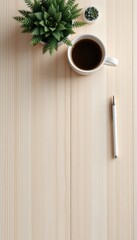 Relaxing workspace setup with beverage and pen on a light wooden surface offering plenty of space