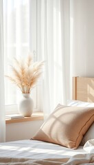 Bright bedroom interior showcasing a bed with soft linens and a vase of plumes on the window sill