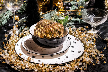 festive Christmas table setting with golden balls and glitter, selective focus 