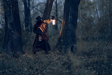 Mysterious figure illuminates dark forest with lantern, evoking gothic atmosphere.