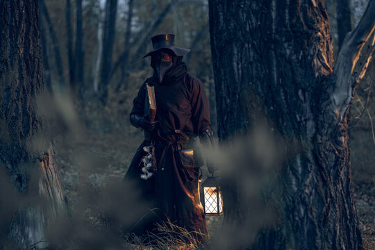Mysterious plague doctor wanders through a dark, misty forest clutching a lantern and book.