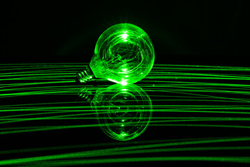 Glowing Glass Lightbulb with green laser lighting it