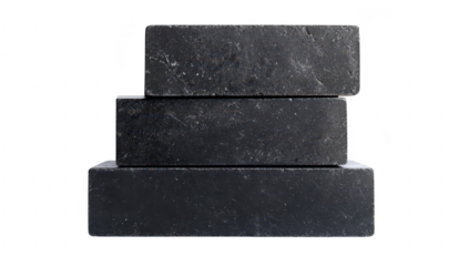 A stack of three rectangular black stones arranged neatly on a white background. their smooth surfaces and subtle textures. ideal for backgrounds or product displays