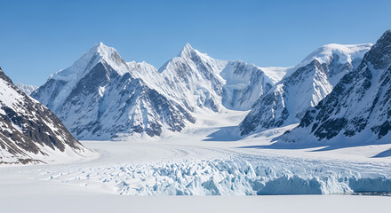 Obraz premium A panoramic view of snow covered mountains and a glacier under a clear blue sky in a remote location