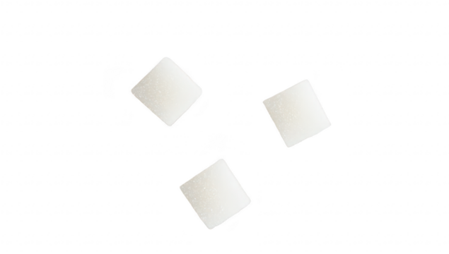 Three white sugar cubes arranged on a clean. bright surface. their geometric shape and texture. ideal for culinary or lifestyle photography